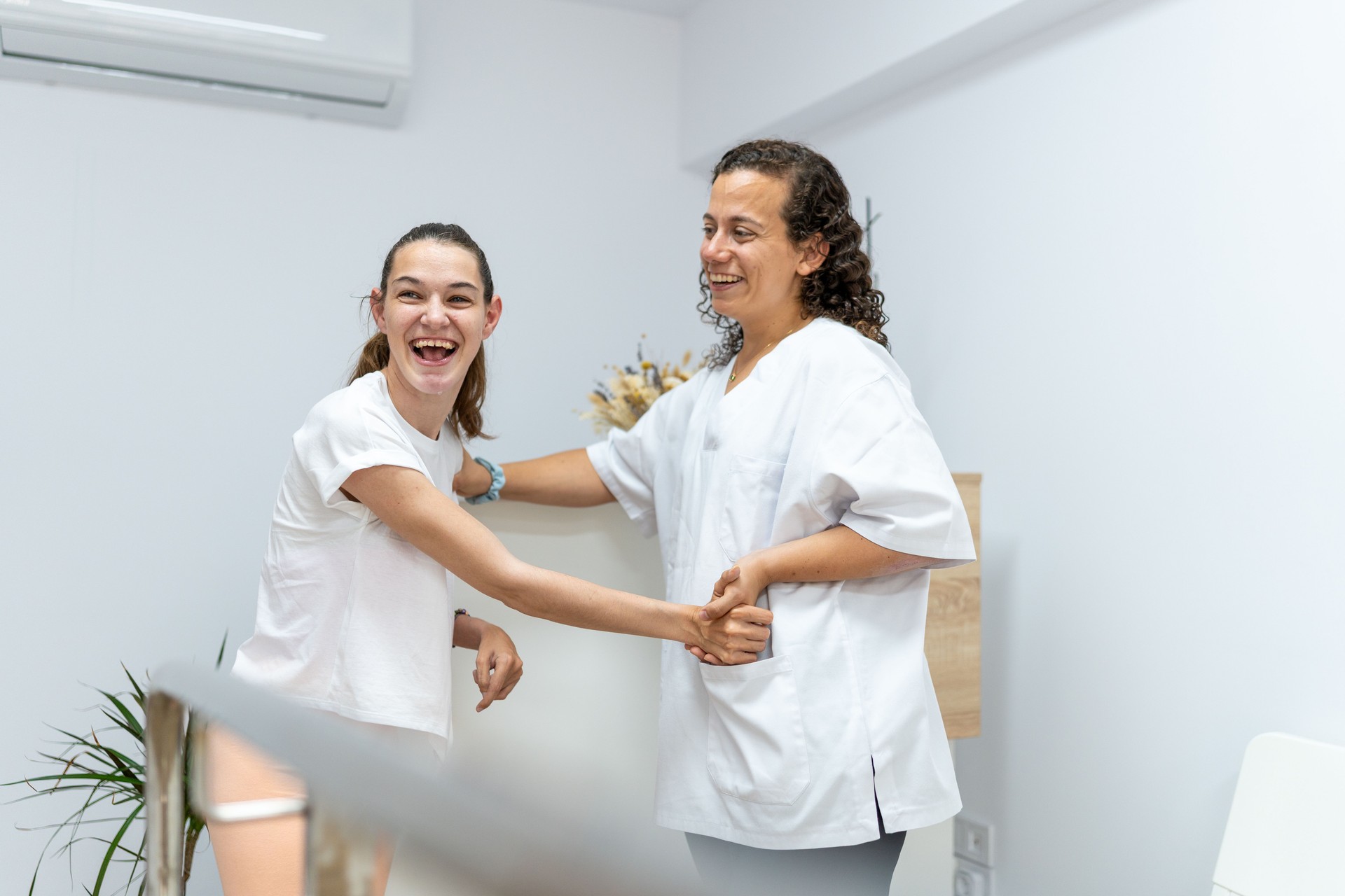 Young Woman with Cerebral Palsy Sharing Laughter with Her Therapist